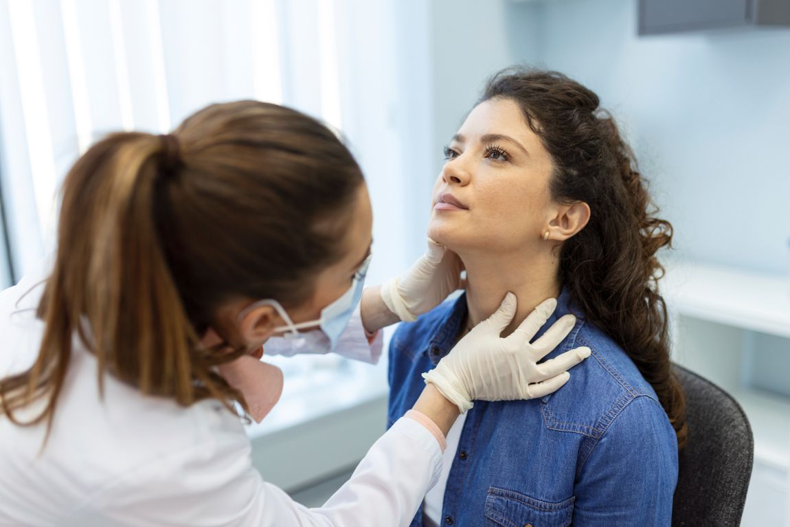 physician evaluating patient for neck cancer